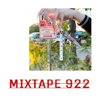 mixtape 922 - a person holding a knife in front of a sign